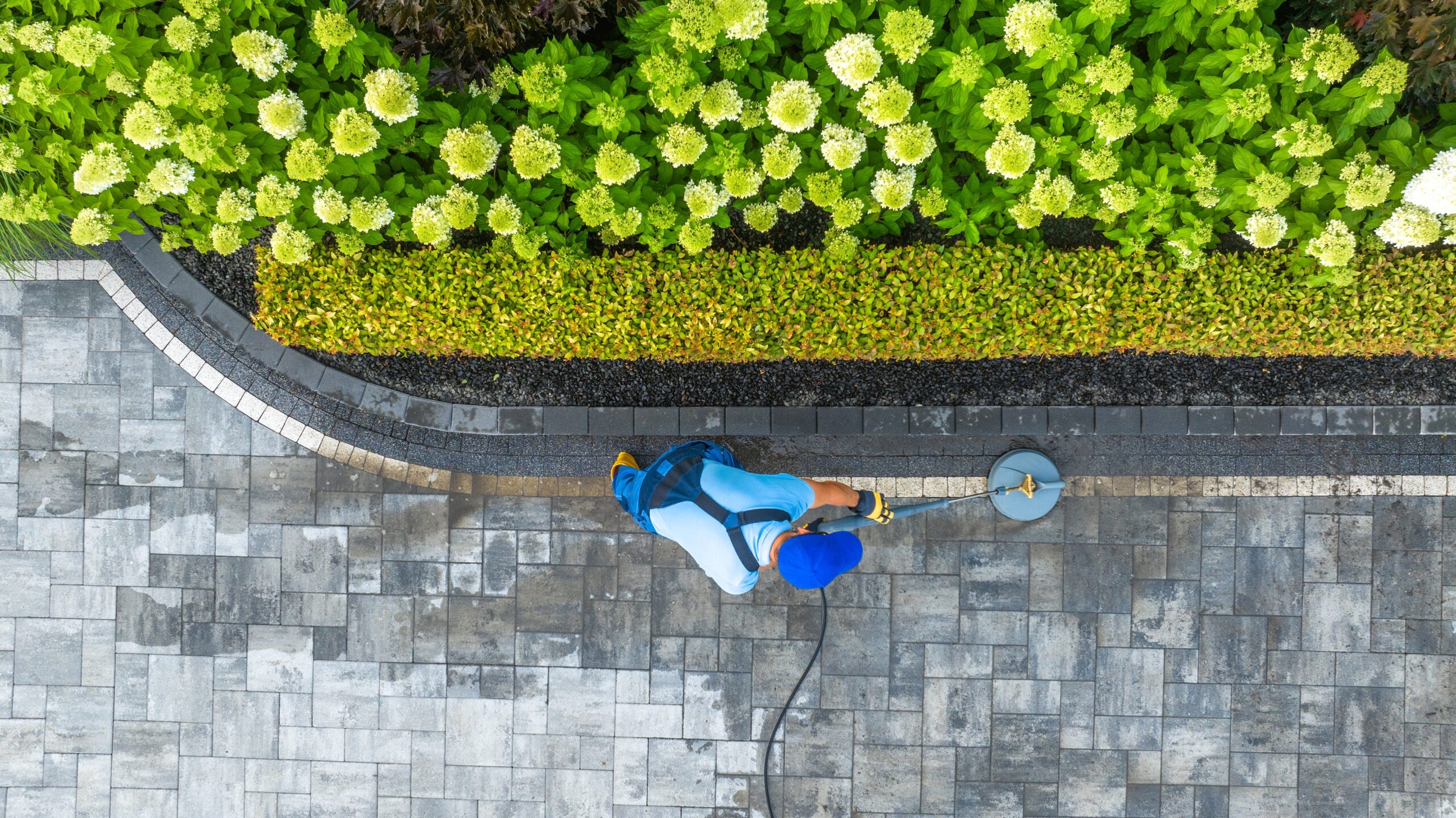 Caucasian,Worker,Washing,Residential,Driveway,Using,Pressure,Washer,Aerial,View